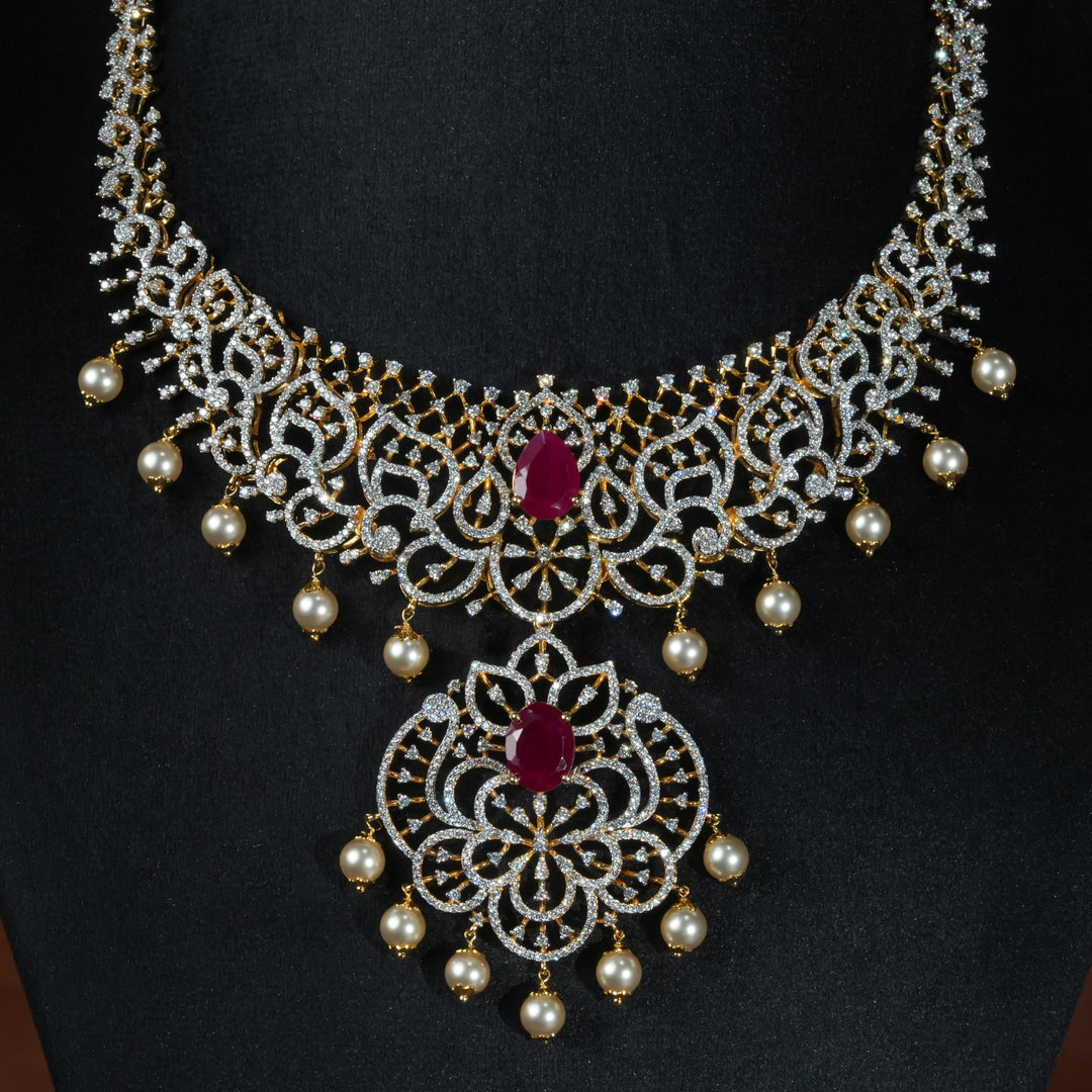 Luxury diamond-look silver necklace with premium cz stones and semi-precious ruby stone in 92.5 silver, bridal wedding jewellery with gold finish by Sri Fine Jewellery Punjagutta Hyderabad.