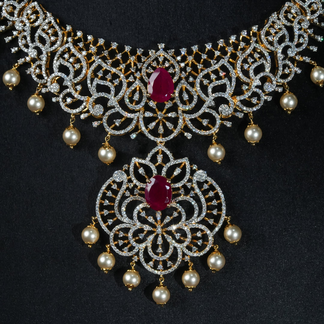 Luxury diamond-look silver necklace with premium cz stones and semi-precious ruby stone in 92.5 silver, bridal wedding jewellery with gold finish by Sri Fine Jewellery Punjagutta Hyderabad.