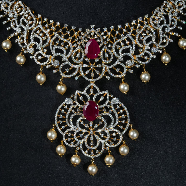 Luxury diamond-look silver necklace with premium cz stones and semi-precious ruby stone in 92.5 silver, bridal wedding jewellery with gold finish by Sri Fine Jewellery Punjagutta Hyderabad.