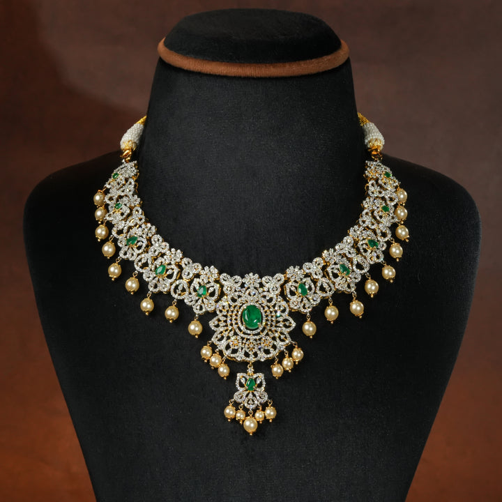Luxury diamond-look silver necklace with premium cz stones and semi-precious emerald stones in 92.5 silver, bridal wedding jewellery with gold finish by Sri Fine Jewellery Punjagutta Hyderabad.