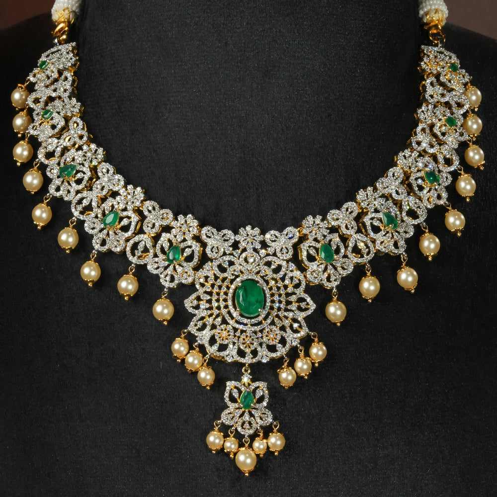 Luxury diamond-look silver necklace with premium cz stones and semi-precious emerald stones in 92.5 silver, bridal wedding jewellery with gold finish by Sri Fine Jewellery Punjagutta Hyderabad.