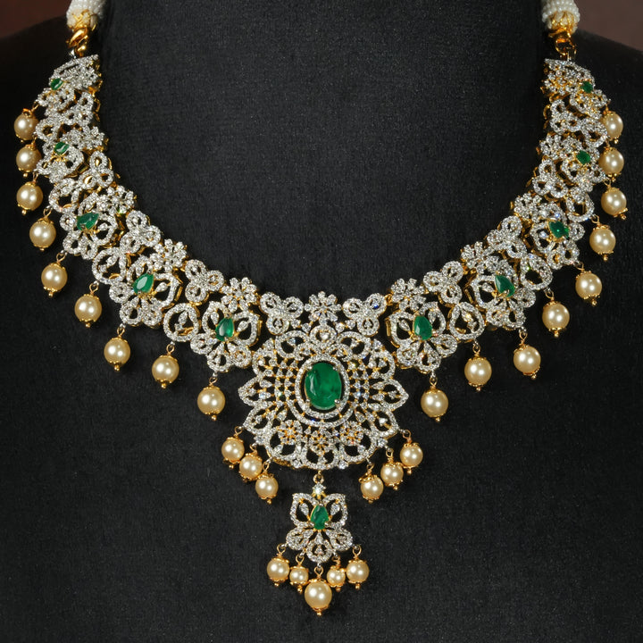 Luxury diamond-look silver necklace with premium cz stones and semi-precious emerald stones in 92.5 silver, bridal wedding jewellery with gold finish by Sri Fine Jewellery Punjagutta Hyderabad.