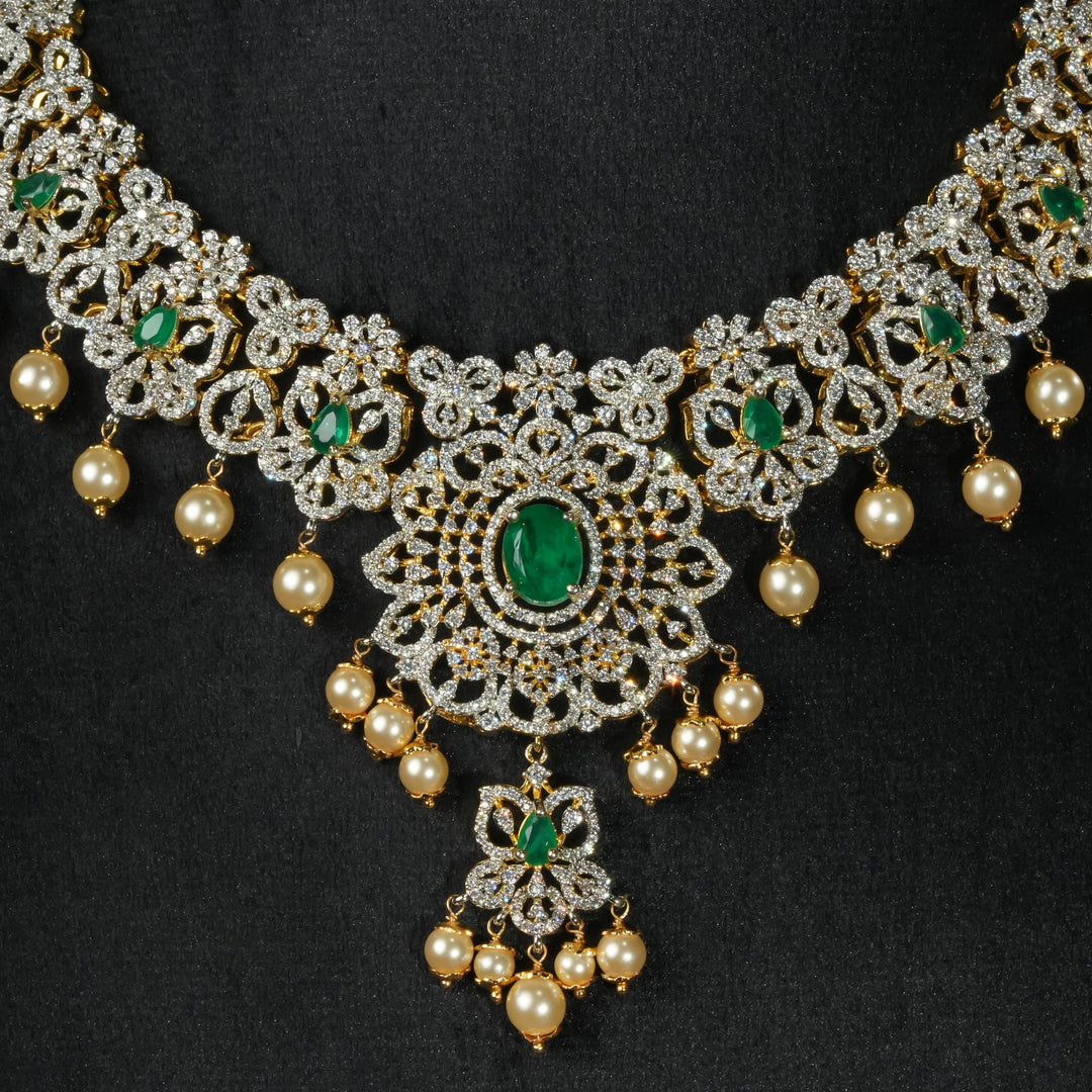 Luxury diamond-look silver necklace with premium cz stones and semi-precious emerald stones in 92.5 silver, bridal wedding jewellery with gold finish by Sri Fine Jewellery Punjagutta Hyderabad.