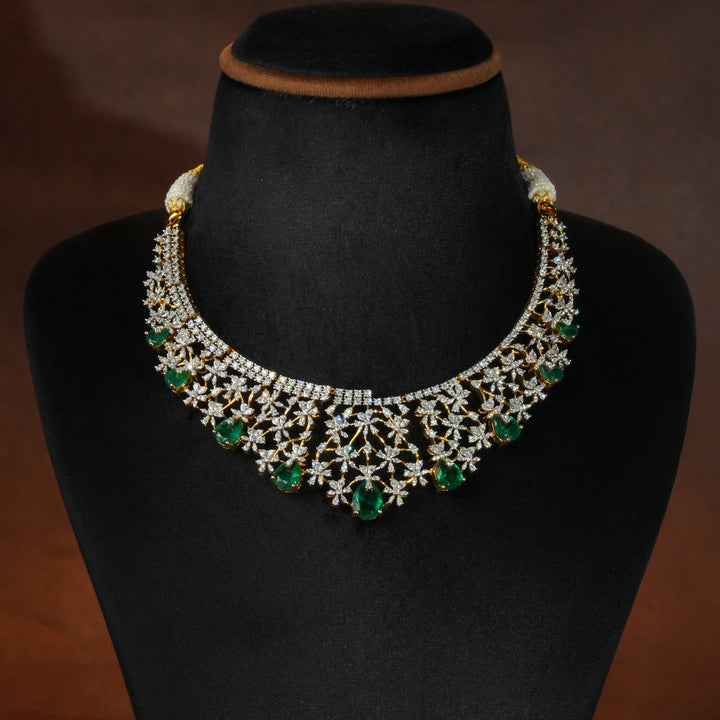 Luxury diamond-look silver necklace with premium cz stones and semi-precious emerald stones in 92.5 silver, bridal wedding jewellery with gold finish by Sri Fine Jewellery Punjagutta Hyderabad.