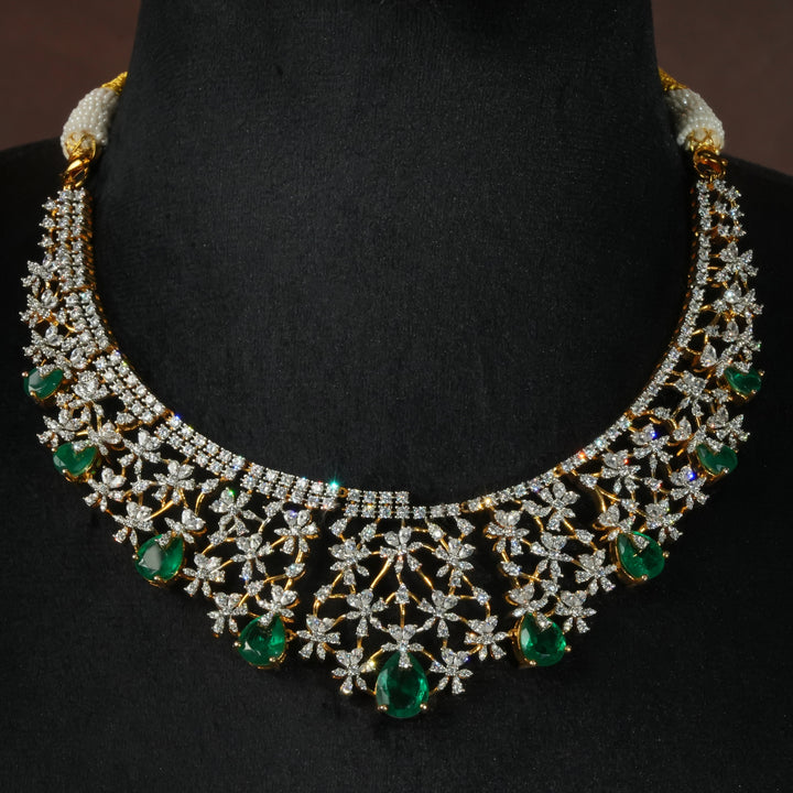 Luxury diamond-look silver necklace with premium cz stones and semi-precious emerald stones in 92.5 silver, bridal wedding jewellery with gold finish by Sri Fine Jewellery Punjagutta Hyderabad.