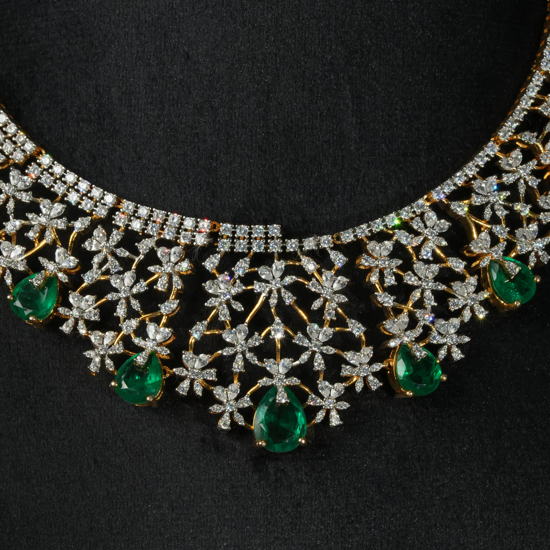 Luxury diamond-look silver necklace with premium cz stones and semi-precious emerald stones in 92.5 silver, bridal wedding jewellery with gold finish by Sri Fine Jewellery Punjagutta Hyderabad.
