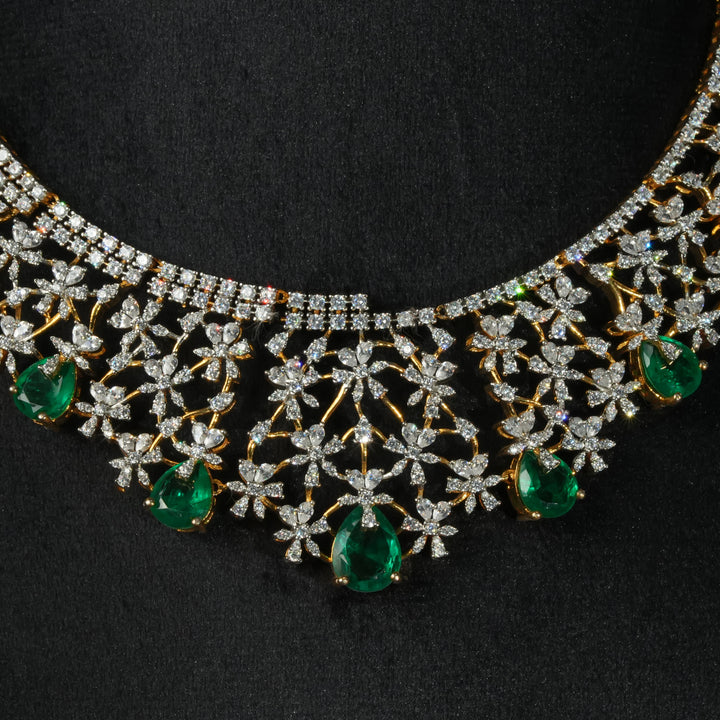 Luxury diamond-look silver necklace with premium cz stones and semi-precious emerald stones in 92.5 silver, bridal wedding jewellery with gold finish by Sri Fine Jewellery Punjagutta Hyderabad.