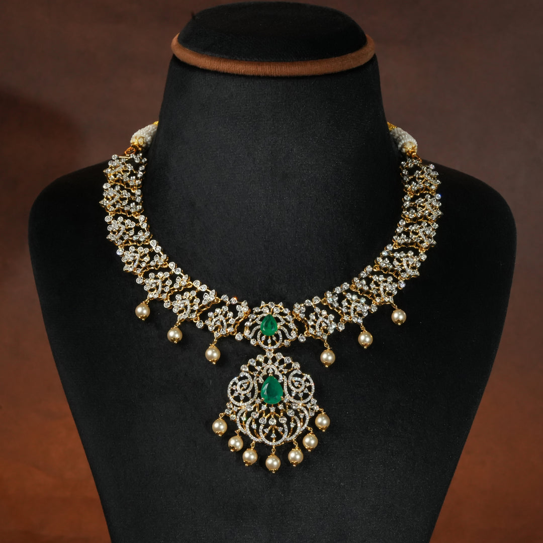 Luxury diamond-look silver necklace with premium cz stones and semi-precious emerald stones in 92.5 silver, bridal wedding jewellery with gold finish by Sri Fine Jewellery Punjagutta Hyderabad.