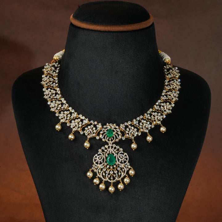 Luxury diamond-look silver necklace with premium cz stones and semi-precious emerald stones in 92.5 silver, bridal wedding jewellery with gold finish by Sri Fine Jewellery Punjagutta Hyderabad.