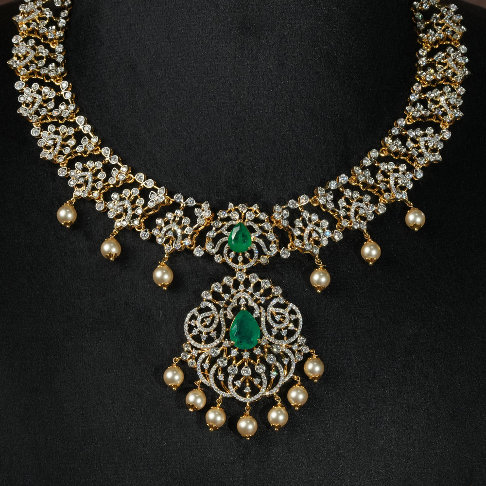 Luxury diamond-look silver necklace with premium cz stones and semi-precious emerald stones in 92.5 silver, bridal wedding jewellery with gold finish by Sri Fine Jewellery Punjagutta Hyderabad.