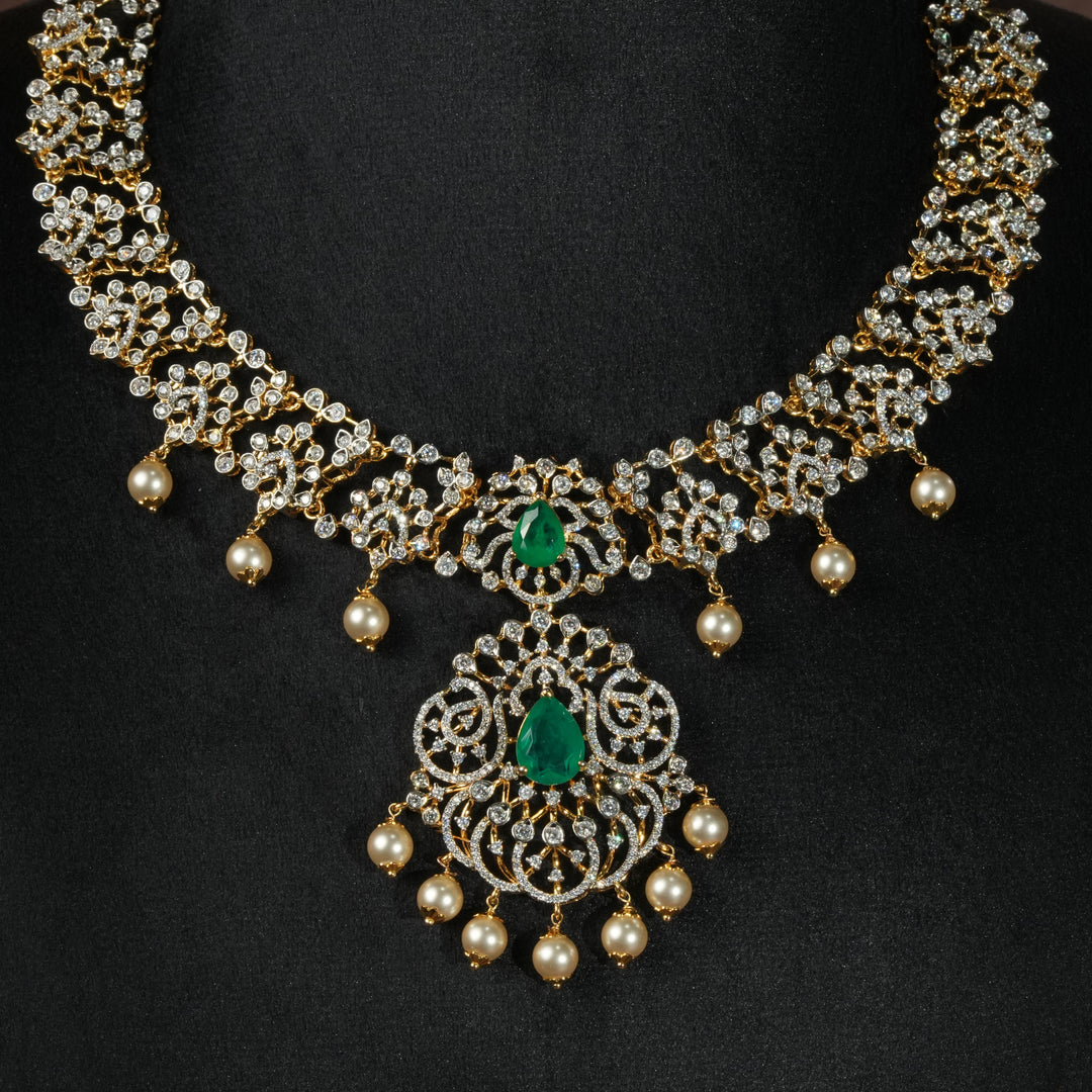 Luxury diamond-look silver necklace with premium cz stones and semi-precious emerald stones in 92.5 silver, bridal wedding jewellery with gold finish by Sri Fine Jewellery Punjagutta Hyderabad.
