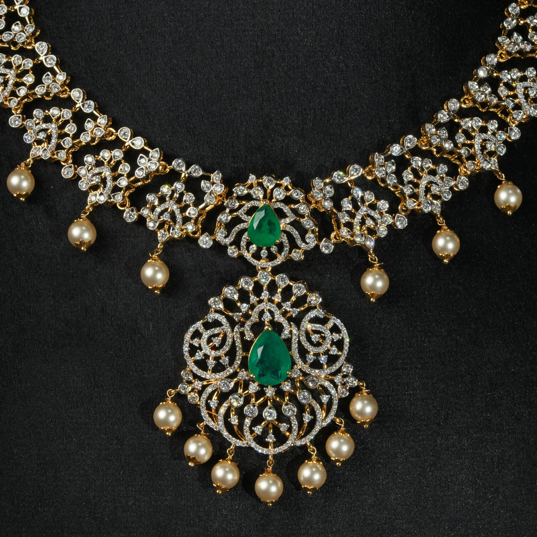 Luxury diamond-look silver necklace with premium cz stones and semi-precious emerald stones in 92.5 silver, bridal wedding jewellery with gold finish by Sri Fine Jewellery Punjagutta Hyderabad.