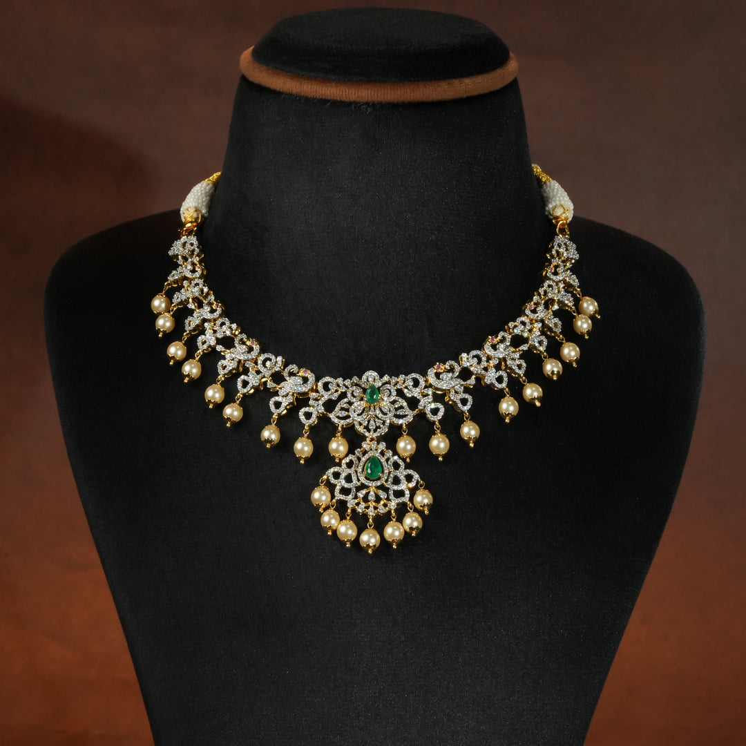 Luxury diamond-look silver necklace with premium cz stones and semi-precious emerald stones in 92.5 silver, bridal wedding jewellery with gold finish by Sri Fine Jewellery Punjagutta Hyderabad.