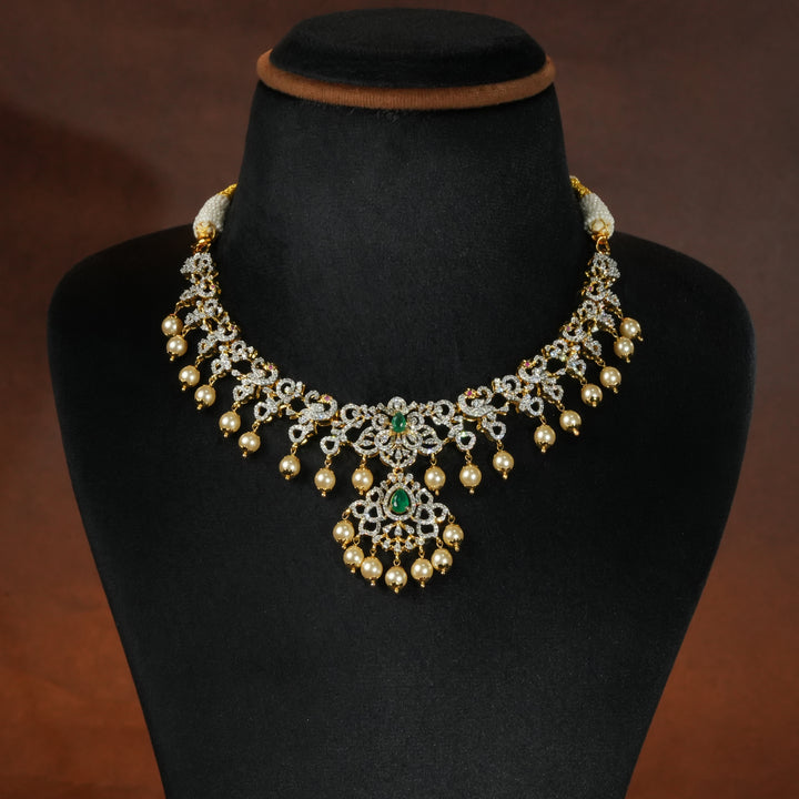 Luxury diamond-look silver necklace with premium cz stones and semi-precious emerald stones in 92.5 silver, bridal wedding jewellery with gold finish by Sri Fine Jewellery Punjagutta Hyderabad.