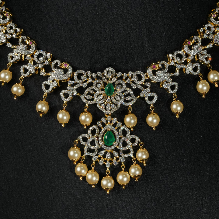 Luxury diamond-look silver necklace with premium cz stones and semi-precious emerald stones in 92.5 silver, bridal wedding jewellery with gold finish by Sri Fine Jewellery Punjagutta Hyderabad.