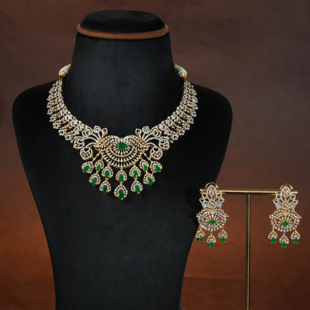 Luxury diamond-look silver necklace set with premium cz stones and semi-precious emerald stones in 92.5 silver, bridal wedding jewellery with gold finish by Sri Fine Jewellery Punjagutta Hyderabad.