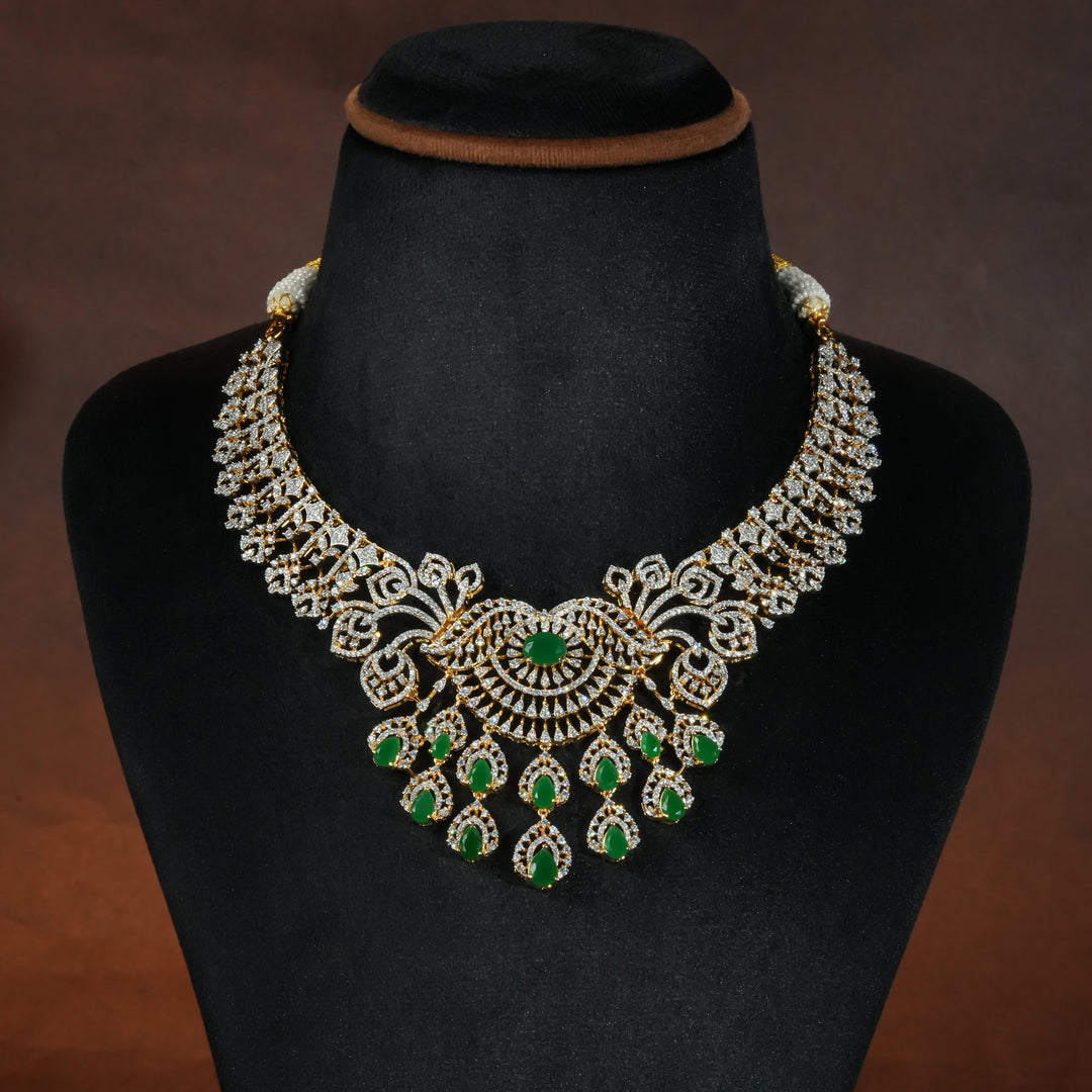 Luxury diamond-look silver necklace set with premium cz stones and semi-precious emerald stones in 92.5 silver, bridal wedding jewellery with gold finish by Sri Fine Jewellery Punjagutta Hyderabad.