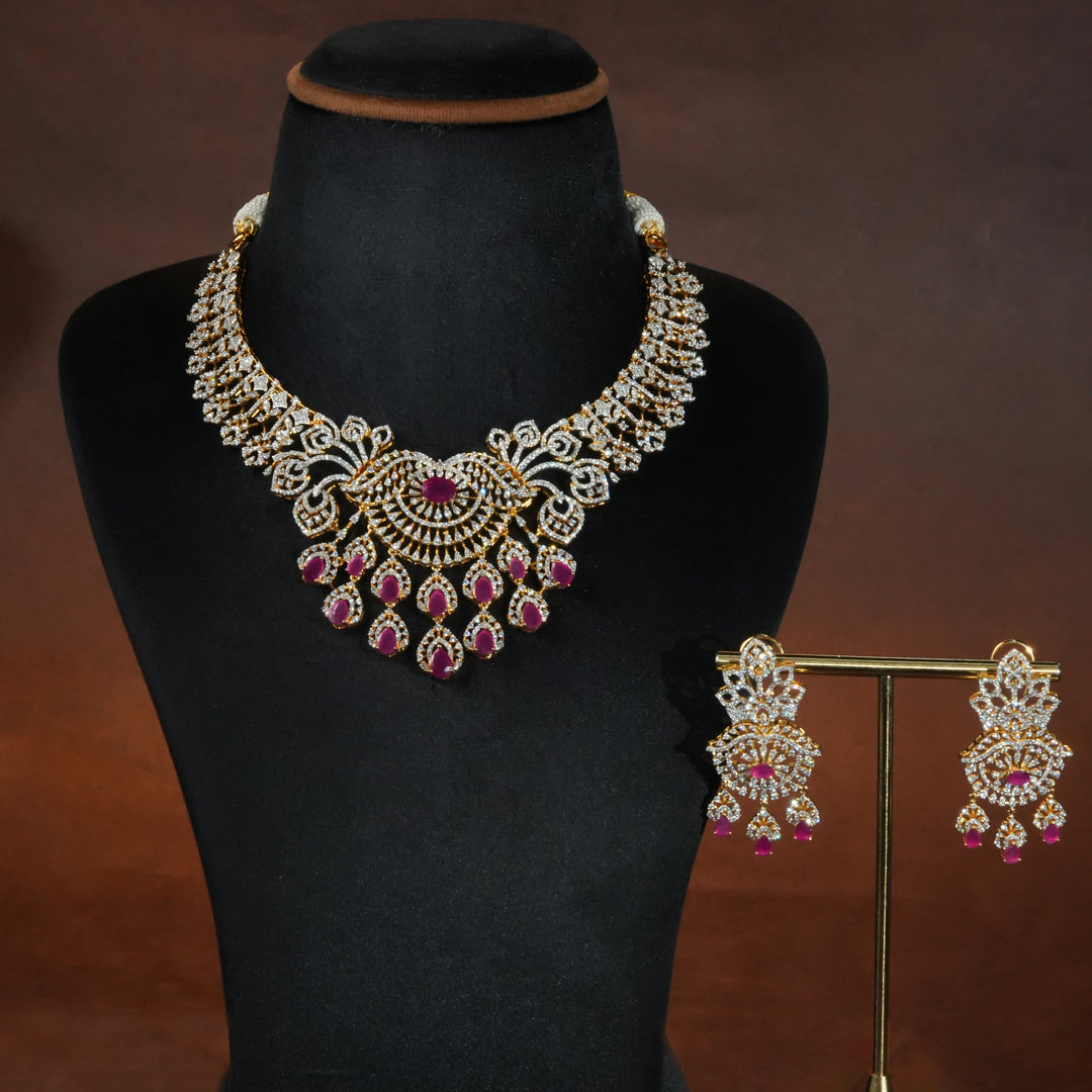 Luxury diamond-look silver necklace set with premium cz stones and semi-precious ruby stones in 92.5 silver, bridal wedding jewellery with gold finish by Sri Fine Jewellery Punjagutta Hyderabad.