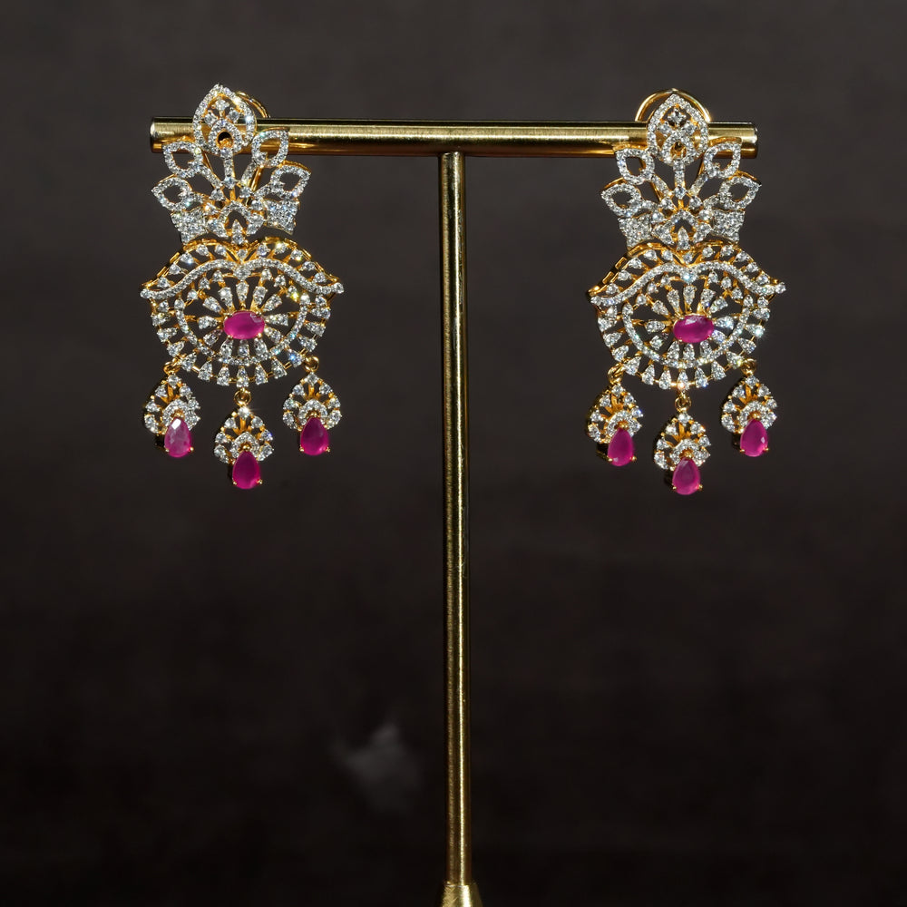Luxury diamond-look silver earrings with premium cz stones and semi-precious ruby stones in 92.5 silver, bridal wedding jewellery with gold finish by Sri Fine Jewellery Punjagutta Hyderabad.