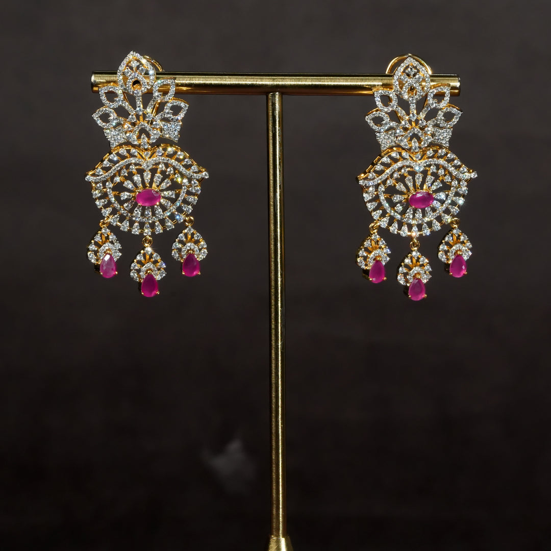Luxury diamond-look silver earrings with premium cz stones and semi-precious ruby stones in 92.5 silver, bridal wedding jewellery with gold finish by Sri Fine Jewellery Punjagutta Hyderabad.