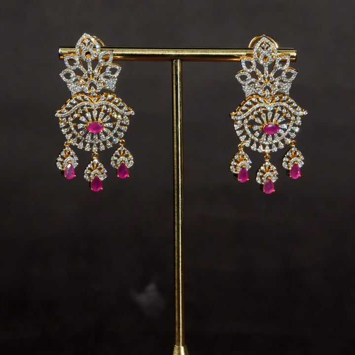 Luxury diamond-look silver earrings with premium cz stones and semi-precious ruby stones in 92.5 silver, bridal wedding jewellery with gold finish by Sri Fine Jewellery Punjagutta Hyderabad.