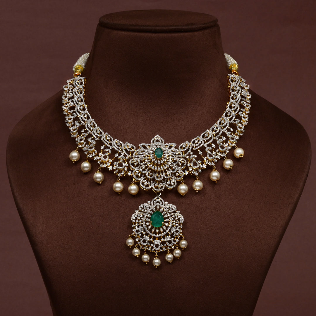 Luxury diamond-look silver necklace with premium cz stones and semi-precious emerald stones in 92.5 silver, bridal wedding jewellery with gold finish by Sri Fine Jewellery Punjagutta Hyderabad.