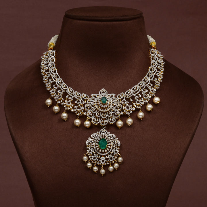 Luxury diamond-look silver necklace with premium cz stones and semi-precious emerald stones in 92.5 silver, bridal wedding jewellery with gold finish by Sri Fine Jewellery Punjagutta Hyderabad.