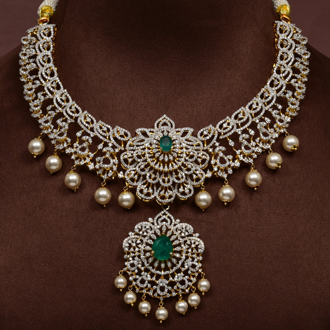 Luxury diamond-look silver necklace with premium cz stones and semi-precious emerald stones in 92.5 silver, bridal wedding jewellery with gold finish by Sri Fine Jewellery Punjagutta Hyderabad.