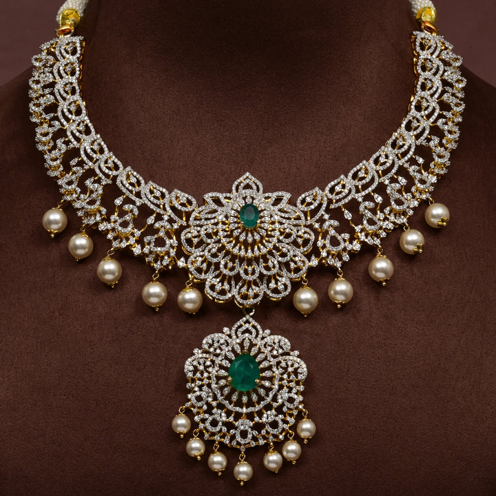 Luxury diamond-look silver necklace with premium cz stones and semi-precious emerald stones in 92.5 silver, bridal wedding jewellery with gold finish by Sri Fine Jewellery Punjagutta Hyderabad.