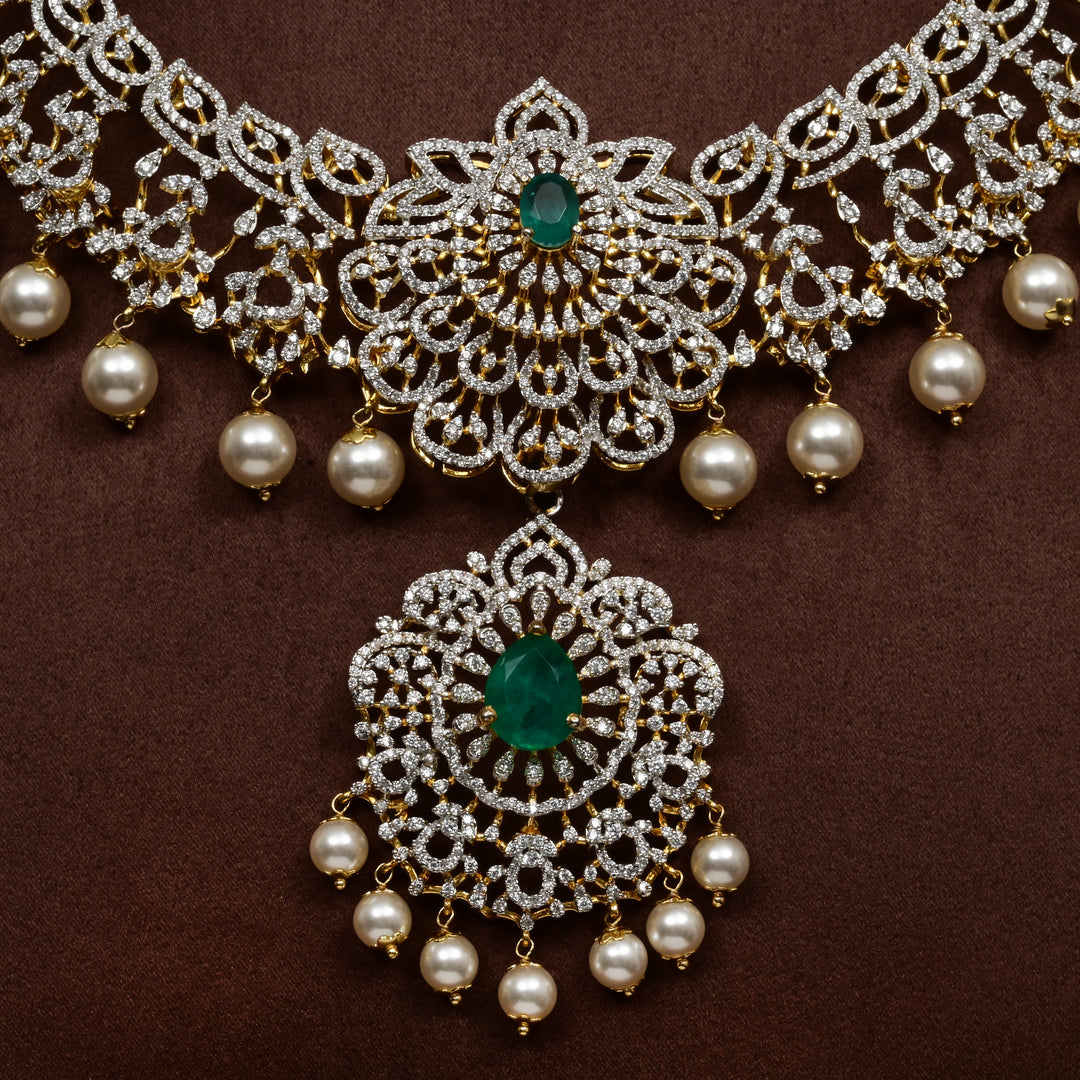 Luxury diamond-look silver necklace with premium cz stones and semi-precious emerald stones in 92.5 silver, bridal wedding jewellery with gold finish by Sri Fine Jewellery Punjagutta Hyderabad.