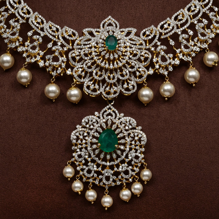Luxury diamond-look silver necklace with premium cz stones and semi-precious emerald stones in 92.5 silver, bridal wedding jewellery with gold finish by Sri Fine Jewellery Punjagutta Hyderabad.