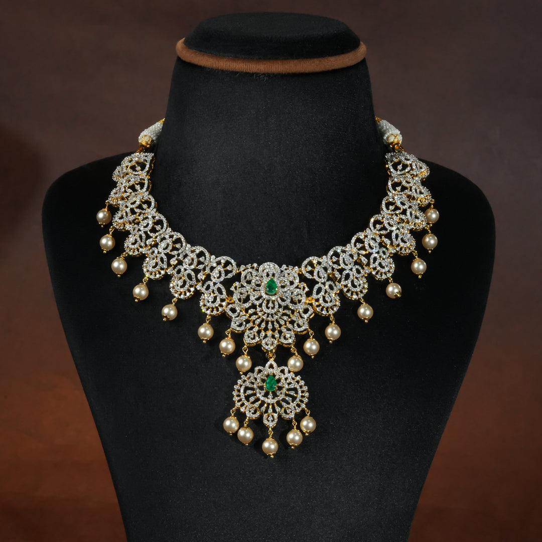 Luxury diamond-look silver necklace with premium cz stones and semi-precious emerald stones in 92.5 silver, bridal wedding jewellery with gold finish by Sri Fine Jewellery Punjagutta Hyderabad.