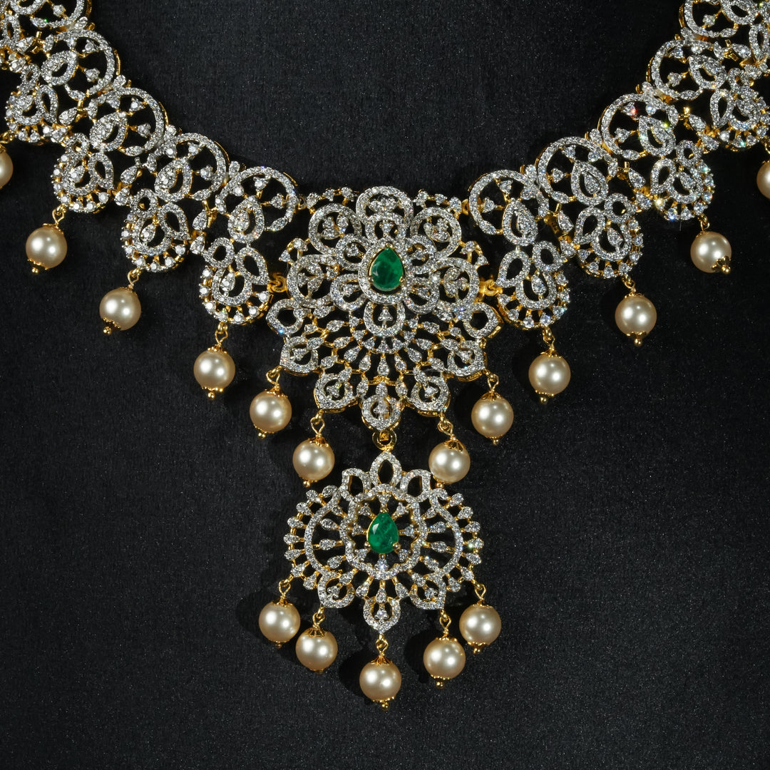 Luxury diamond-look silver necklace with premium cz stones and semi-precious emerald stones in 92.5 silver, bridal wedding jewellery with gold finish by Sri Fine Jewellery Punjagutta Hyderabad.