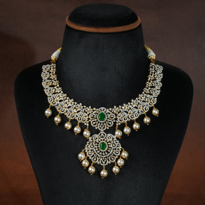 Luxury diamond-look silver necklace with premium cz stones and semi-precious emerald stones in 92.5 silver, bridal wedding jewellery with gold finish by Sri Fine Jewellery Punjagutta Hyderabad.