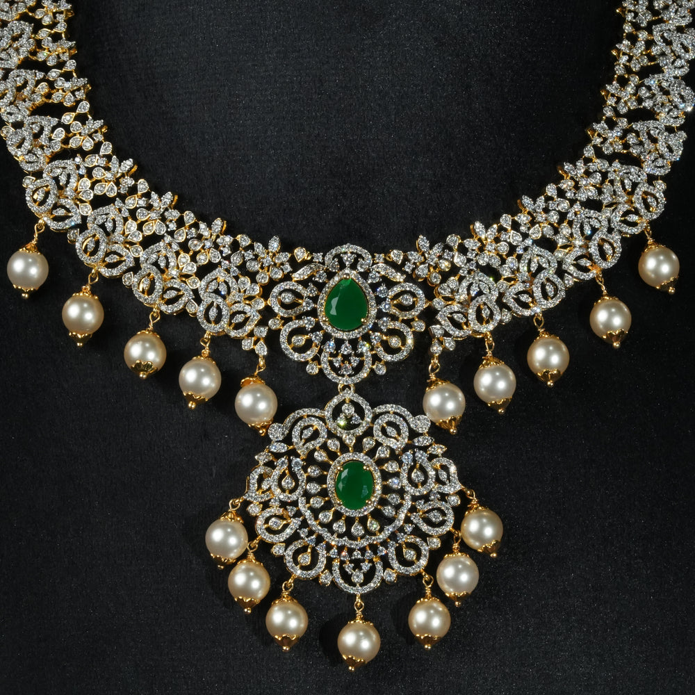 Luxury diamond-look silver necklace with premium cz stones and semi-precious emerald stones in 92.5 silver, bridal wedding jewellery with gold finish by Sri Fine Jewellery Punjagutta Hyderabad.