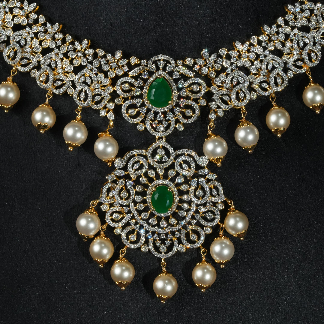Luxury diamond-look silver necklace with premium cz stones and semi-precious emerald stones in 92.5 silver, bridal wedding jewellery with gold finish by Sri Fine Jewellery Punjagutta Hyderabad.