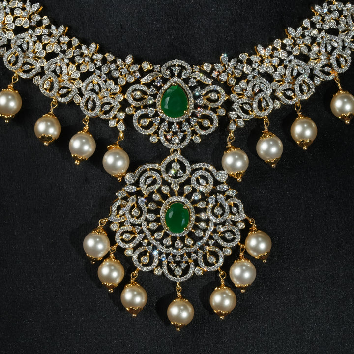 Luxury diamond-look silver necklace with premium cz stones and semi-precious emerald stones in 92.5 silver, bridal wedding jewellery with gold finish by Sri Fine Jewellery Punjagutta Hyderabad.