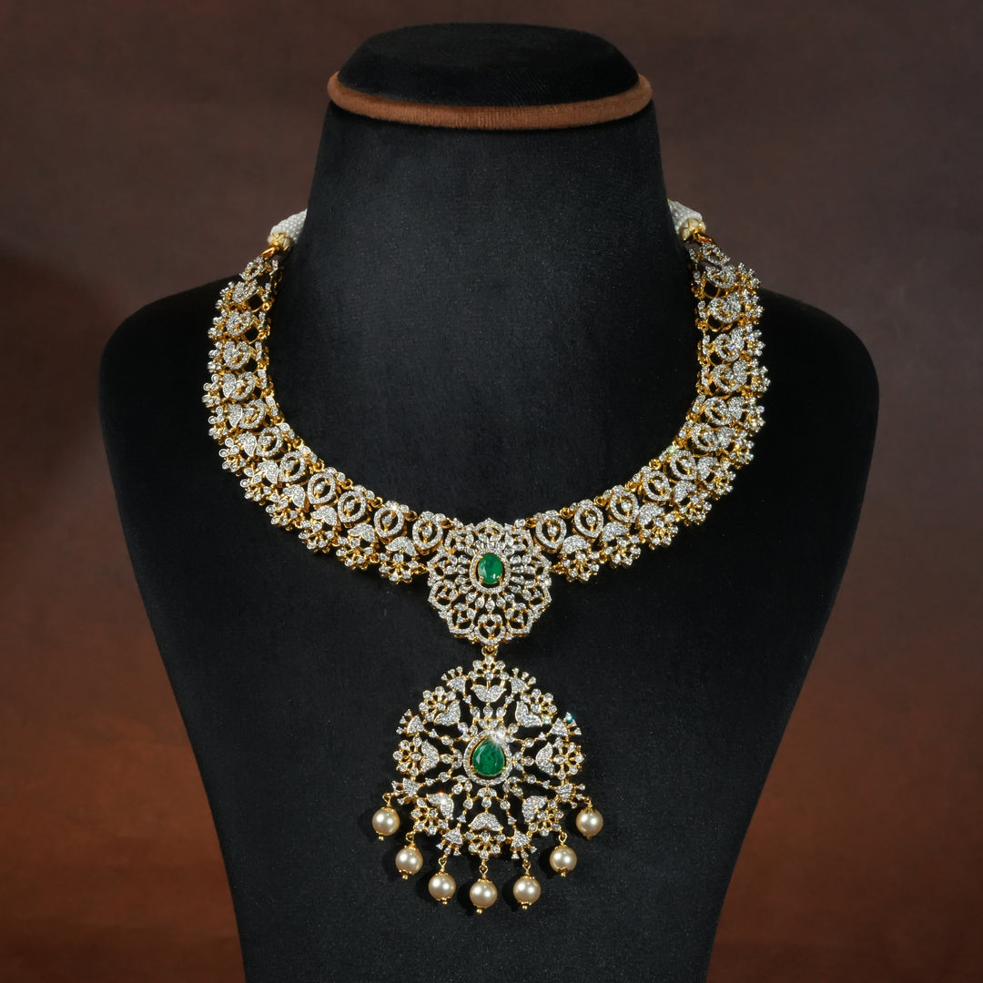 Luxury diamond-look silver necklace with premium cz stones and semi-precious emerald stones in 92.5 silver, bridal wedding jewellery with gold finish by Sri Fine Jewellery Punjagutta Hyderabad.