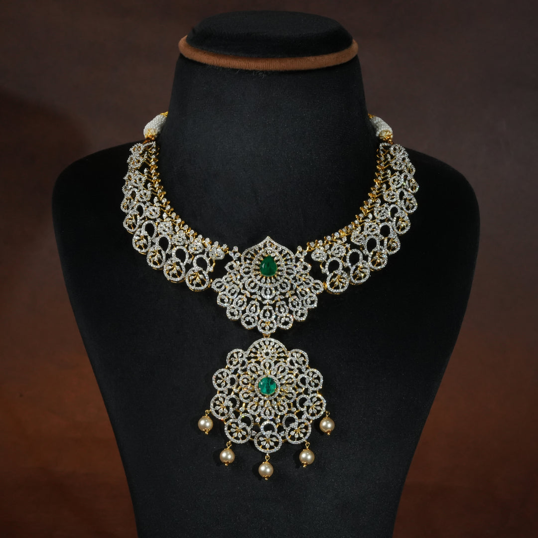 Luxury diamond-look silver necklace with premium cz stones and semi-precious emerald stones in 92.5 silver, bridal wedding jewellery with gold finish by Sri Fine Jewellery Punjagutta Hyderabad.