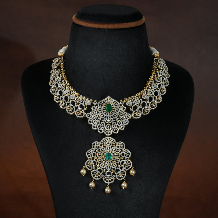 Luxury diamond-look silver necklace with premium cz stones and semi-precious emerald stones in 92.5 silver, bridal wedding jewellery with gold finish by Sri Fine Jewellery Punjagutta Hyderabad.