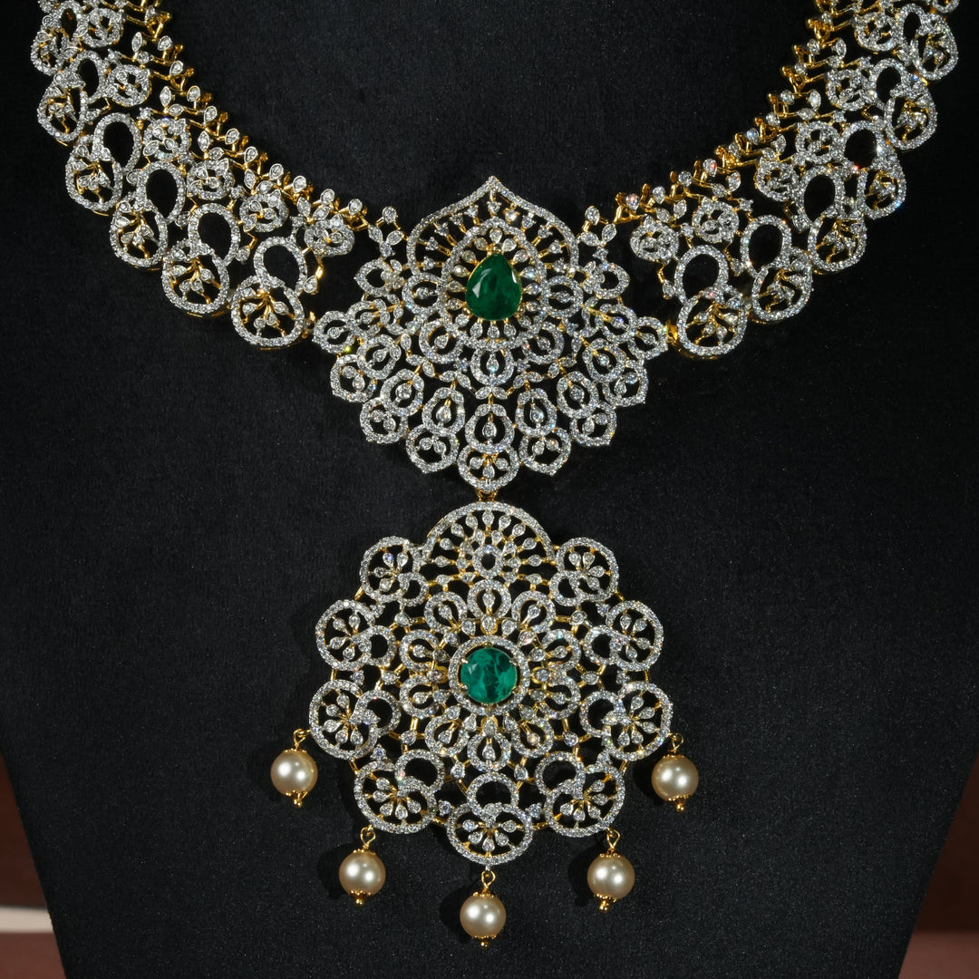 Luxury diamond-look silver necklace with premium cz stones and semi-precious emerald stones in 92.5 silver, bridal wedding jewellery with gold finish by Sri Fine Jewellery Punjagutta Hyderabad.