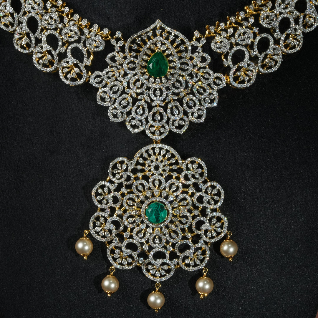 Luxury diamond-look silver necklace with premium cz stones and semi-precious emerald stones in 92.5 silver, bridal wedding jewellery with gold finish by Sri Fine Jewellery Punjagutta Hyderabad.