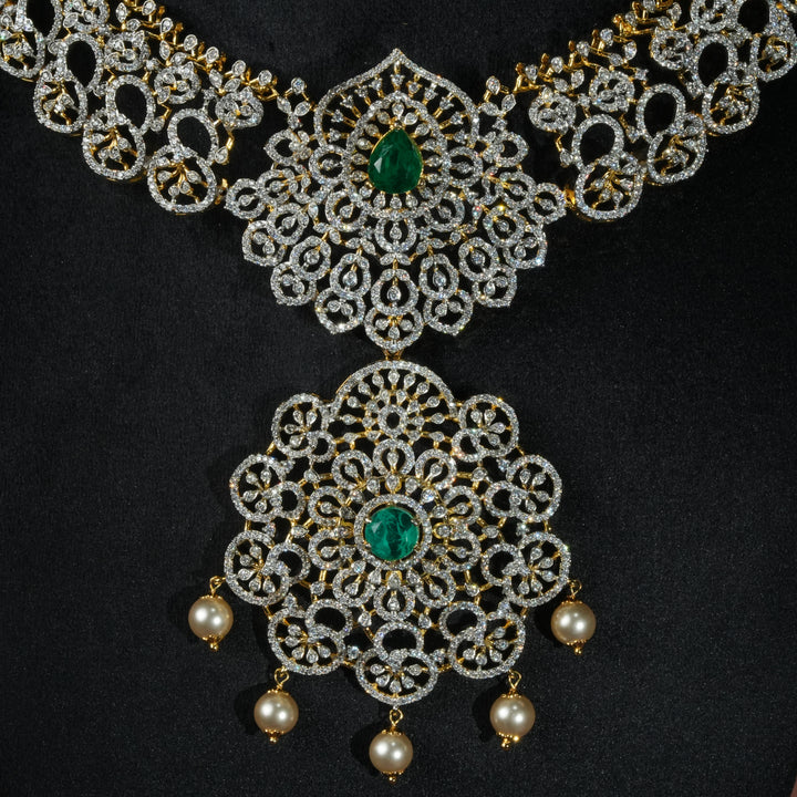 Luxury diamond-look silver necklace with premium cz stones and semi-precious emerald stones in 92.5 silver, bridal wedding jewellery with gold finish by Sri Fine Jewellery Punjagutta Hyderabad.