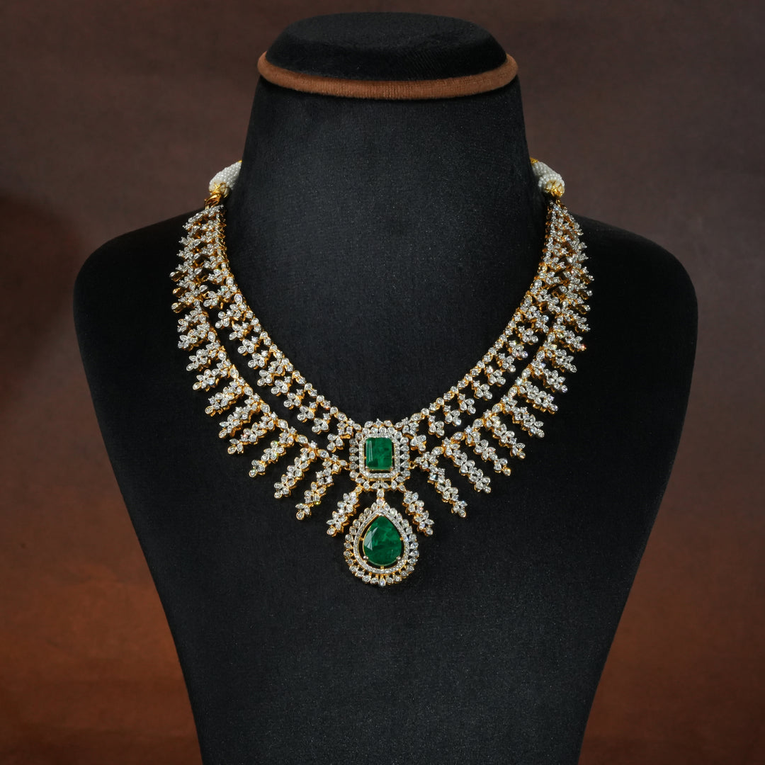 Luxury diamond-look silver necklace with premium cz stones and semi-precious emerald stones in 92.5 silver, bridal wedding jewellery with gold finish by Sri Fine Jewellery Punjagutta Hyderabad.