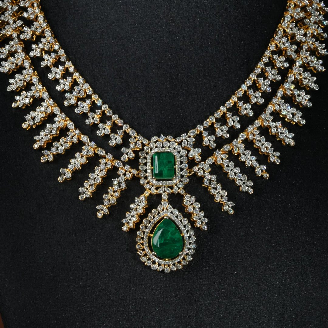 Luxury diamond-look silver necklace with premium cz stones and semi-precious emerald stones in 92.5 silver, bridal wedding jewellery with gold finish by Sri Fine Jewellery Punjagutta Hyderabad.