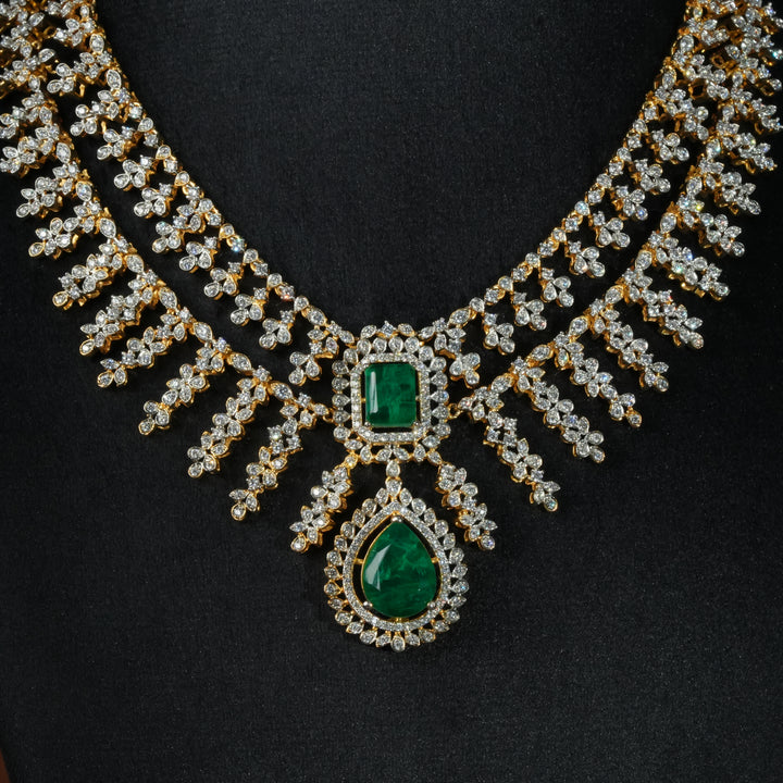 Luxury diamond-look silver necklace with premium cz stones and semi-precious emerald stones in 92.5 silver, bridal wedding jewellery with gold finish by Sri Fine Jewellery Punjagutta Hyderabad.