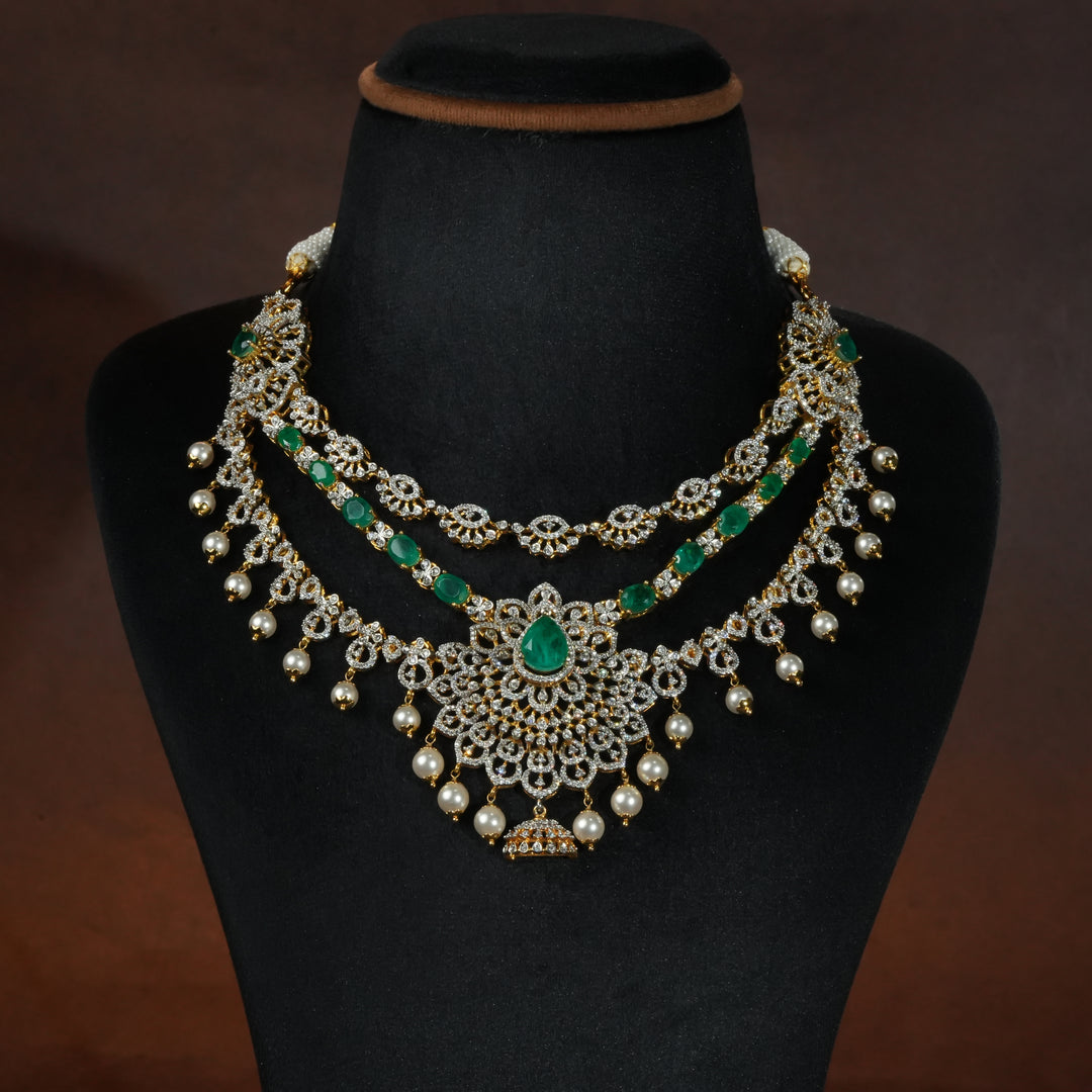 Luxury diamond-look silver necklace with premium cz stones and semi-precious emerald stones in 92.5 silver, bridal wedding jewellery with gold finish by Sri Fine Jewellery Punjagutta Hyderabad.