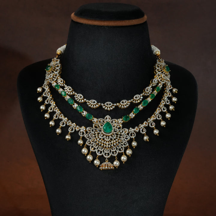 Luxury diamond-look silver necklace with premium cz stones and semi-precious emerald stones in 92.5 silver, bridal wedding jewellery with gold finish by Sri Fine Jewellery Punjagutta Hyderabad.