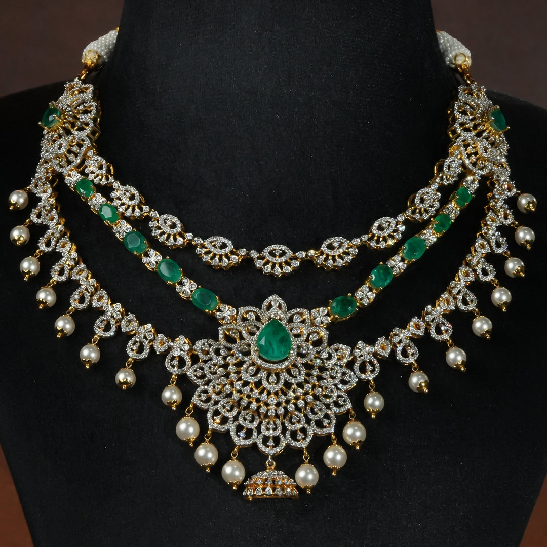 Luxury diamond-look silver necklace with premium cz stones and semi-precious emerald stones in 92.5 silver, bridal wedding jewellery with gold finish by Sri Fine Jewellery Punjagutta Hyderabad.