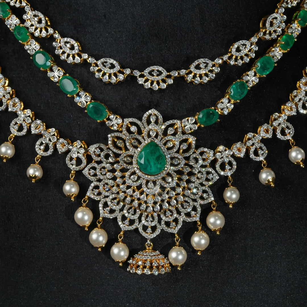 Luxury diamond-look silver necklace with premium cz stones and semi-precious emerald stones in 92.5 silver, bridal wedding jewellery with gold finish by Sri Fine Jewellery Punjagutta Hyderabad.